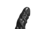 A black Goodvibes Rippler, a tall, slightly curved dildo with prominent ridges