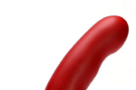 A blood-red Tantus General, a thick, smooth, slightly curved insertable