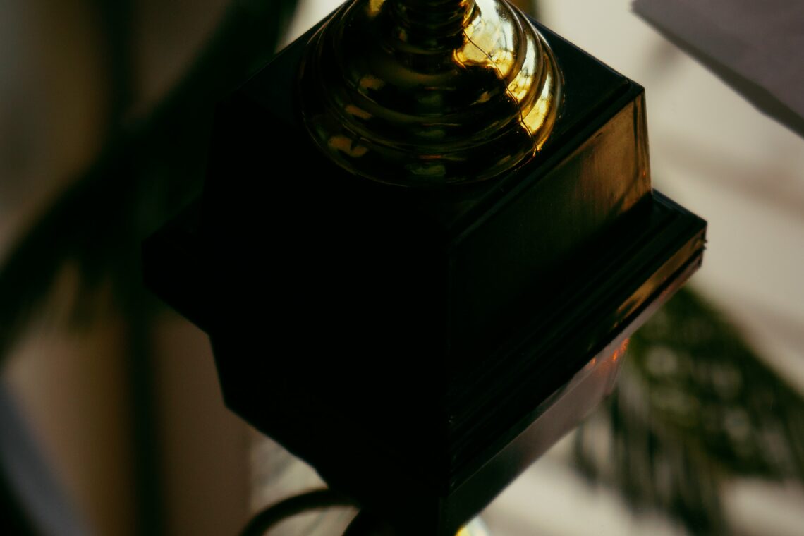 Photo of two golden cup trophies stacked on top of one another courtesy of Robin Edqvist on Unsplash