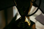 Photo of two golden cup trophies stacked on top of one another courtesy of Robin Edqvist on Unsplash