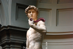 Image composite of the Statue of David with a Tantus harness and strap-on on his hips, and a NobEssence Seducation lying along his arm.