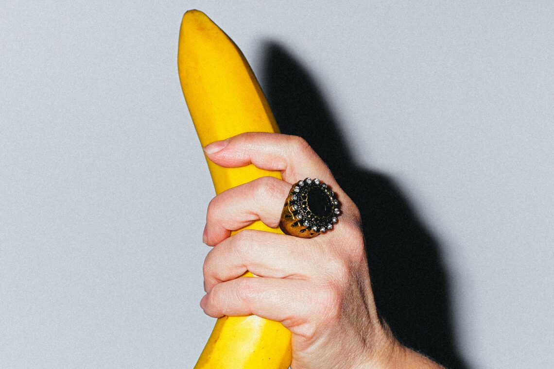 person holding a banana in its peel